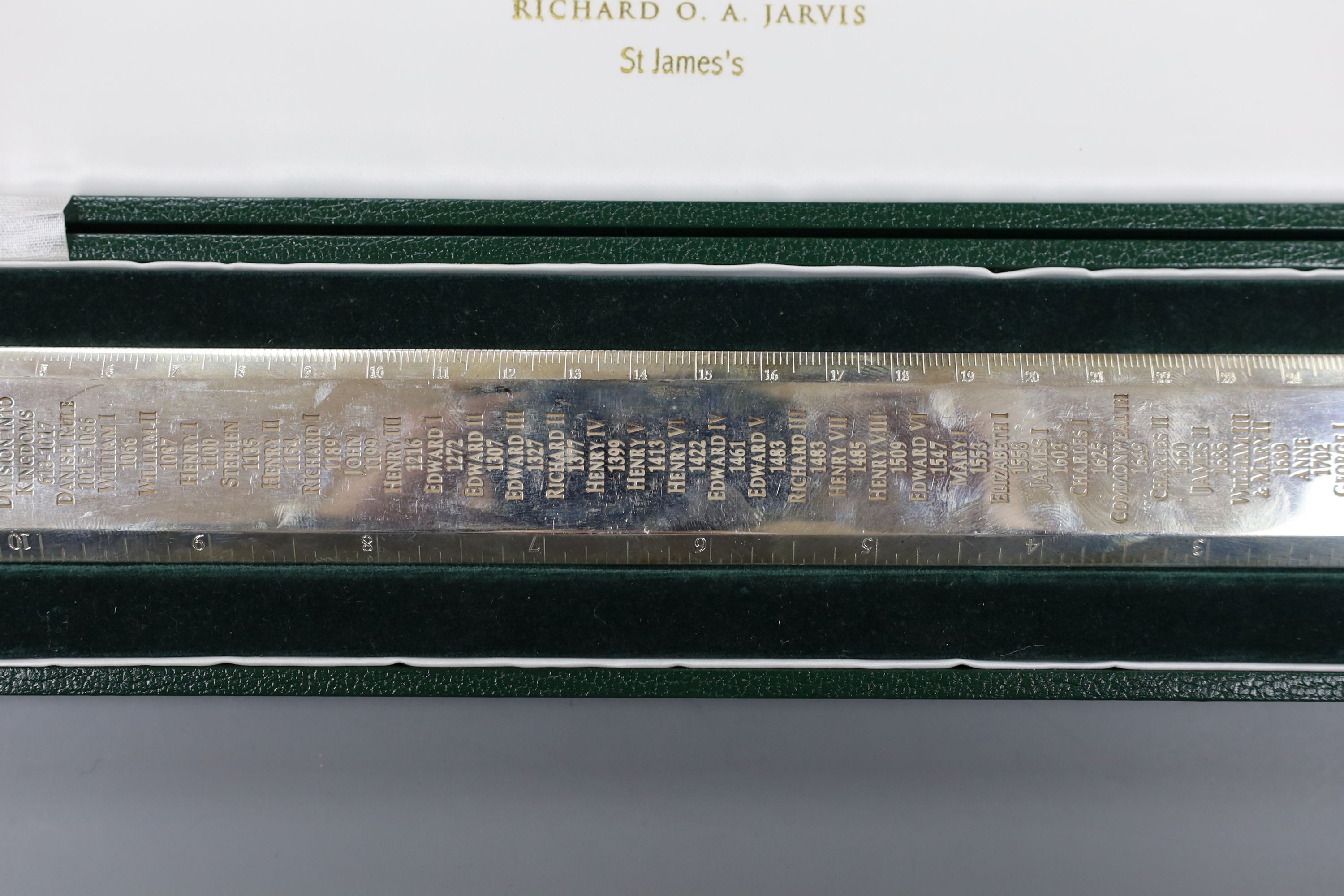 A cased modern Britannia standard silver 'Rule' ruler, engraved with the names and dates of the English Monarchy, by Richard O. A. Jarvis, London, 1977, 9.5oz.